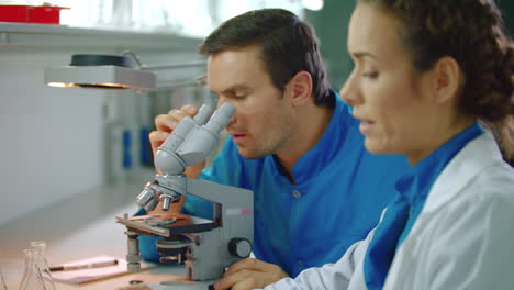 Doctors-team-working-in-lab.-Lab-scientist-working-with-microscope-and-tablet-pc